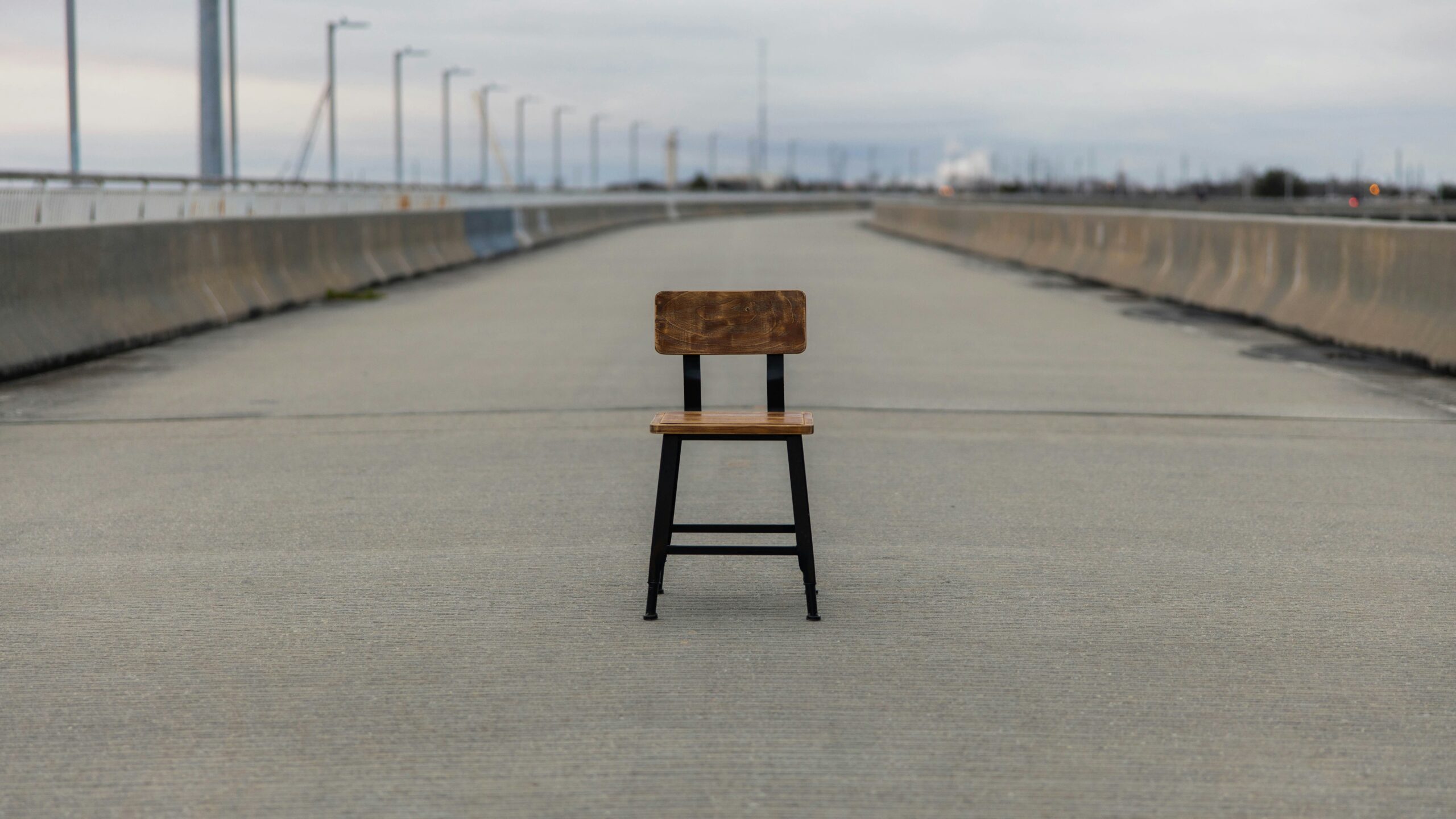 Empty chair on deserted highway.
